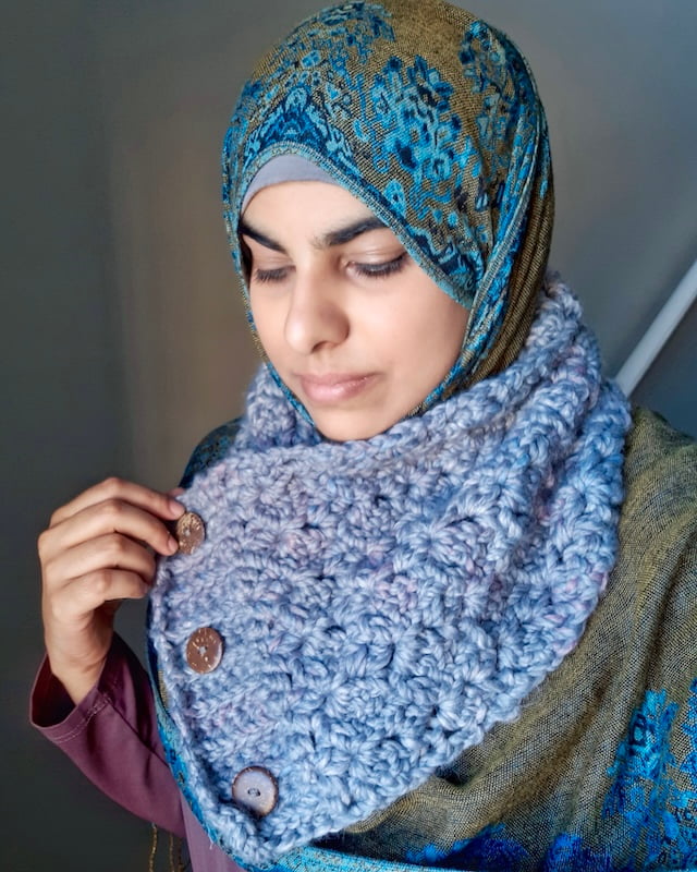 Muslim Indian woman wearing blue and gold hijab and a grey crochet buttoned cowl