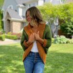 Blond woman wearing green and gold textured crochet shrug with oversized ribbed collar