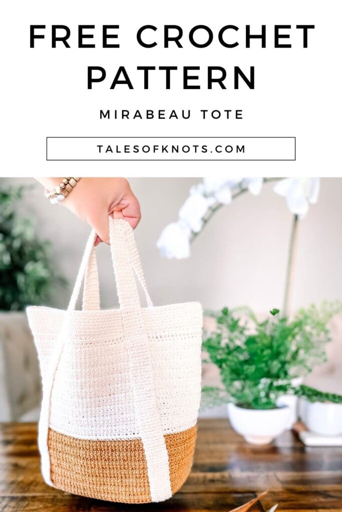 Mirabeau crochet tote bag in cream and mustard, held over a coffee table with yarn and hook nearby