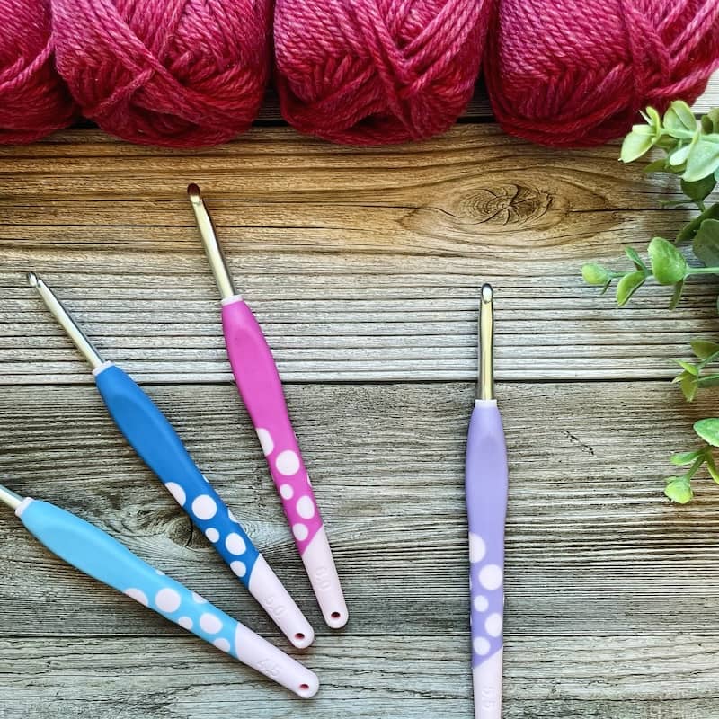 4 We Crochet Dots hooks featuring aluminum tapered shaft and rubberised handle in shades of blue, pink and purple.